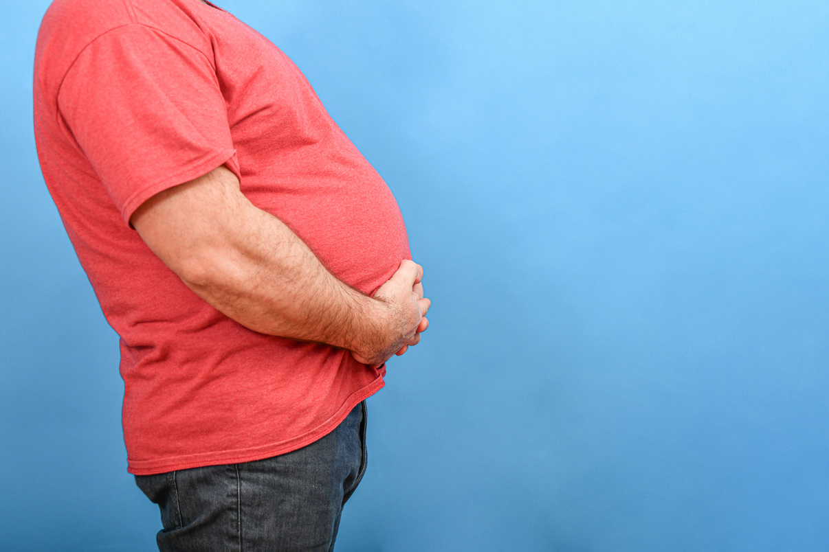 Man with a Big Belly on Blue Background